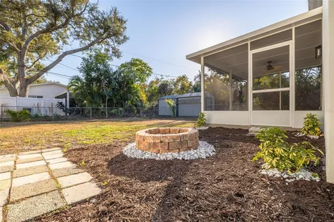 a view of a house with backyard and sitting area