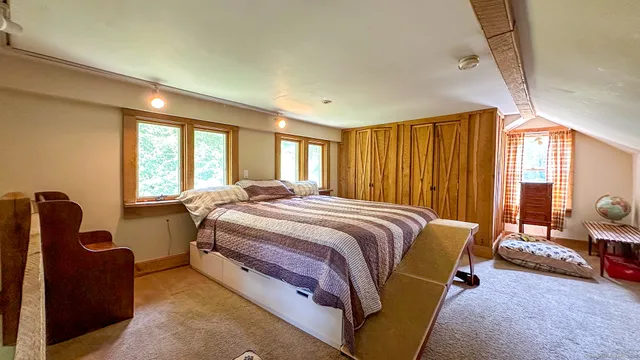 a bed room with a bed and a chair