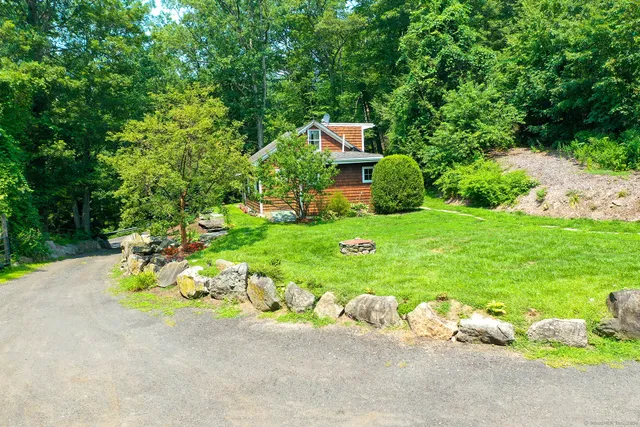 a backyard of a house with a garden and plants
