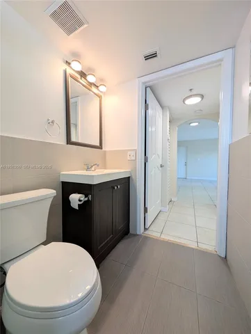 a bathroom with a sink a toilet and mirror
