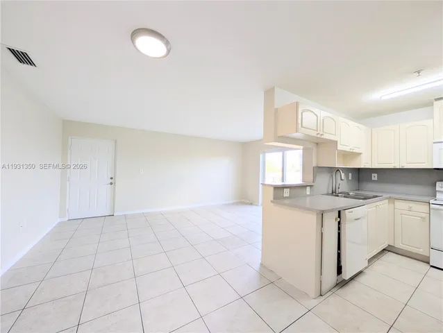 a kitchen with a sink cabinets and window