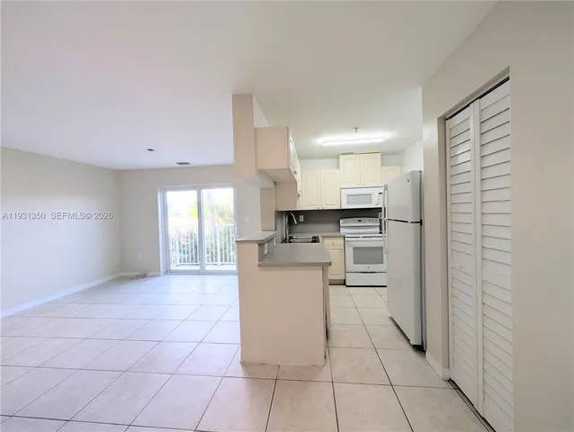 a kitchen with stainless steel appliances a refrigerator sink and cabinets