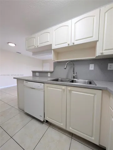 a kitchen with white cabinets