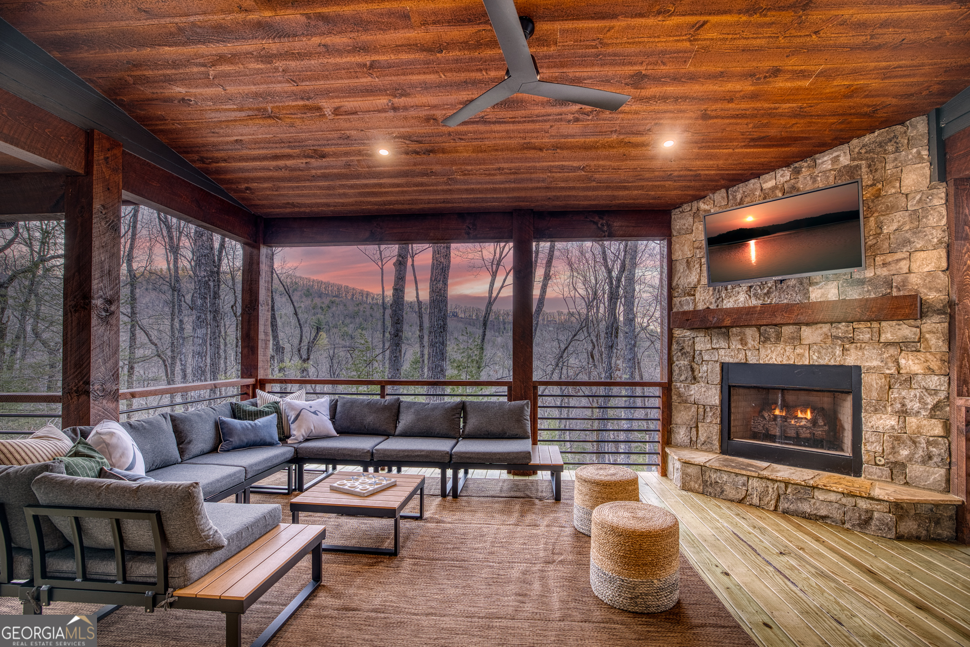 1160 Mangum's Trail Blue Ridge, GA 30513 - Photo 68 of 75 a living room with furniture a fireplace a flat screen tv and floor to ceiling window