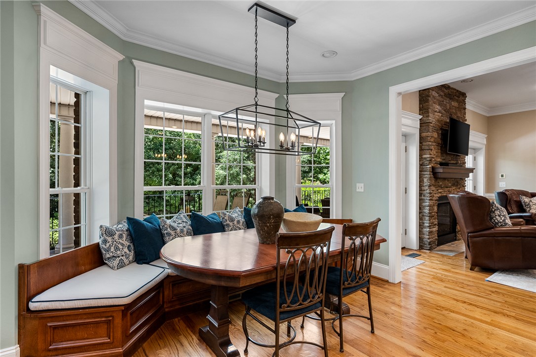 200 Graylyn Drive Anderson, SC 29621 - Photo 14 of 48 A well-lit dining area offers built-in bench seating and warm hardwood floors.