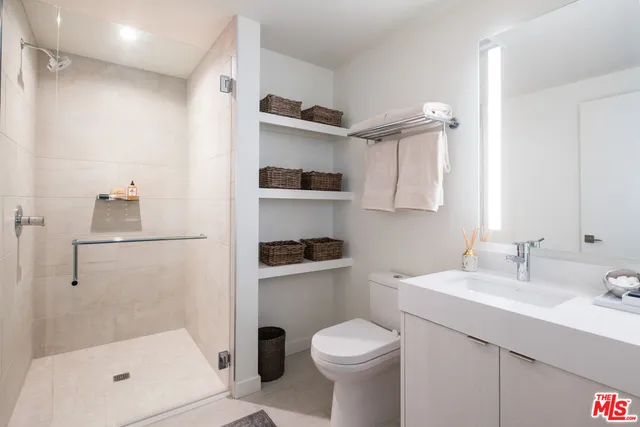 a kitchen with appliances cabinets and chair