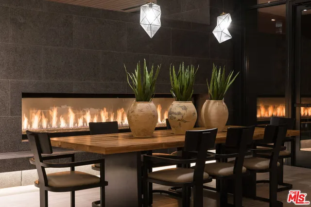 a view of a patio with table and chairs barbeque oven and potted plants