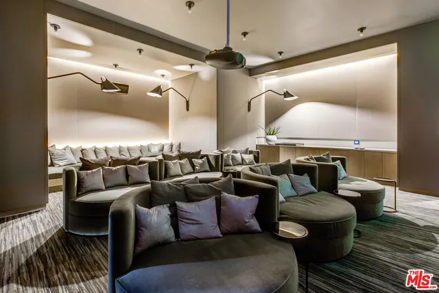 a media room with lots of chairs and a projector screen
