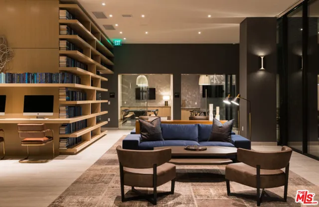 a living room with furniture and a floor to ceiling window