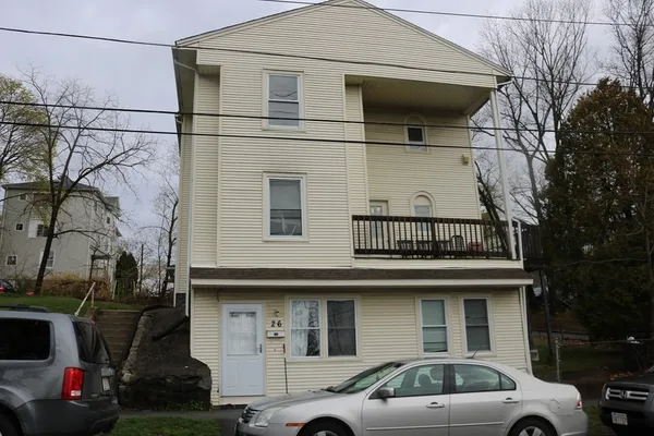 a front view of a house with parking space