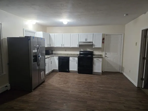 a kitchen with stainless steel appliances granite countertop a stove a refrigerator and a sink