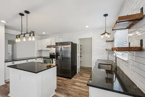 a kitchen with stainless steel appliances granite countertop a sink a counter space and stainless steel appliances