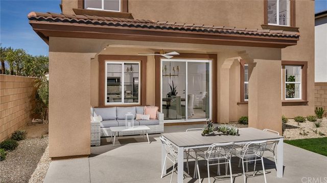 a view of a house with a table and chairs