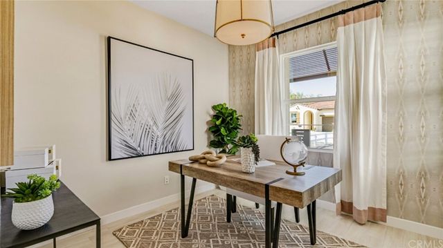 a view of a room with furniture and wooden floor