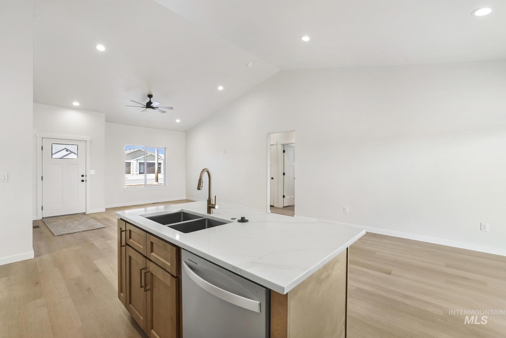 2014 Regan Street Jerome, ID 83338 - Photo 32 of 32 Kitchen featuring open floor plan, brown cabinets, dishwasher, light wood-type flooring, and recessed lighting