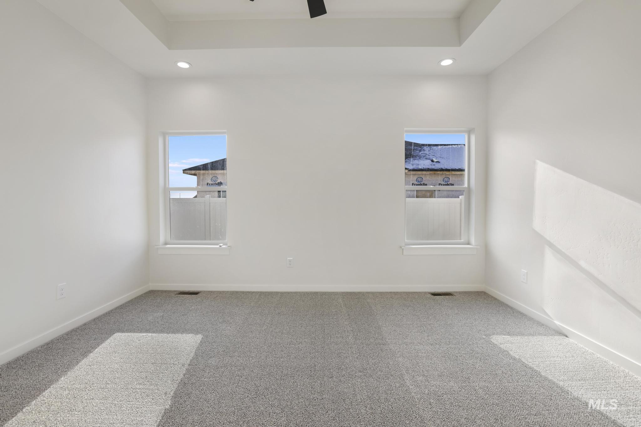 2014 Regan Street Jerome, ID 83338 - Photo 14 of 32 Master bedroom with light carpet, plenty of natural light, recessed lighting, and ceiling fan