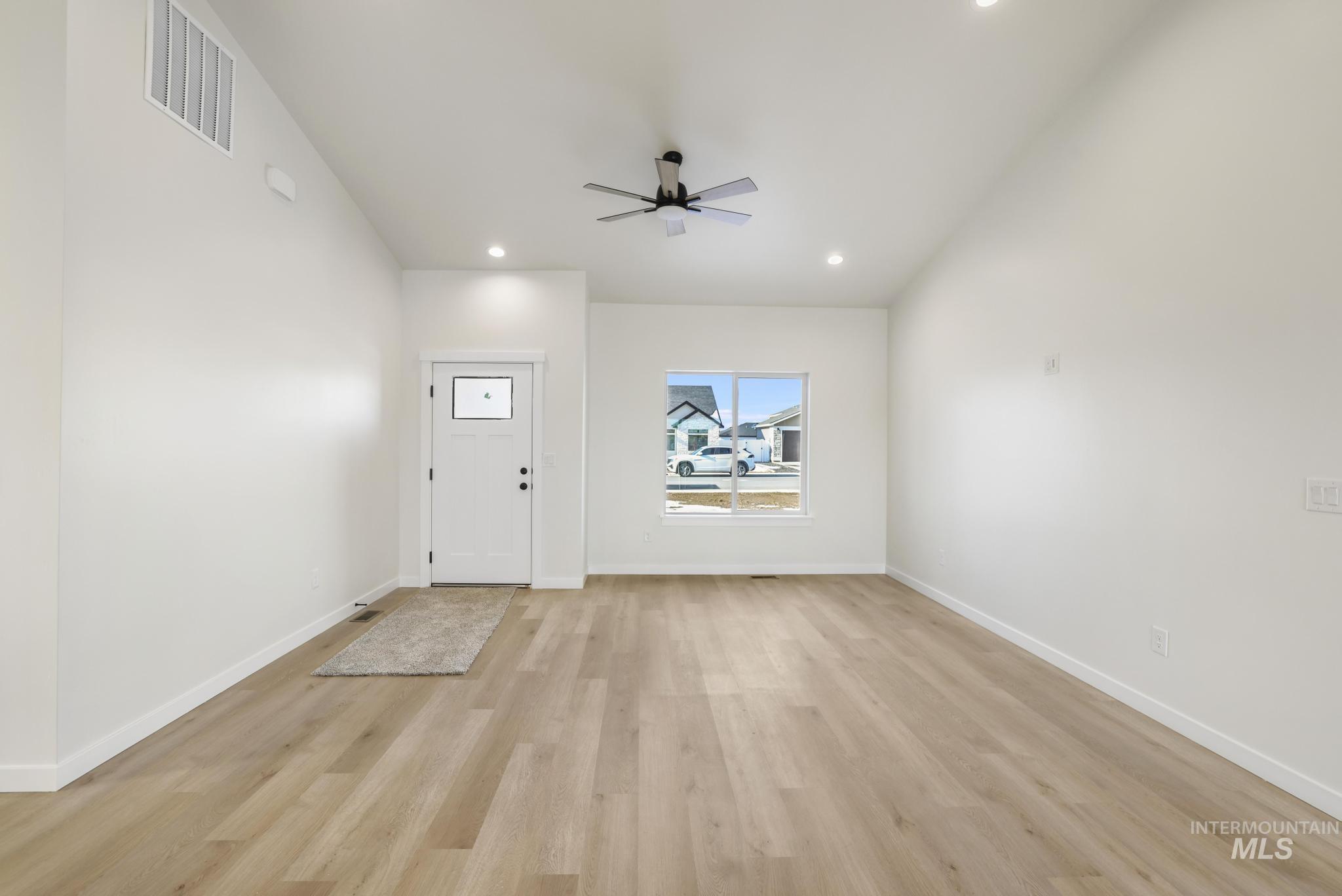 2014 Regan Street Jerome, ID 83338 - Photo 7 of 32 Living room/Front entrance featuring light wood-style flooring, recessed lighting, and ceiling fan