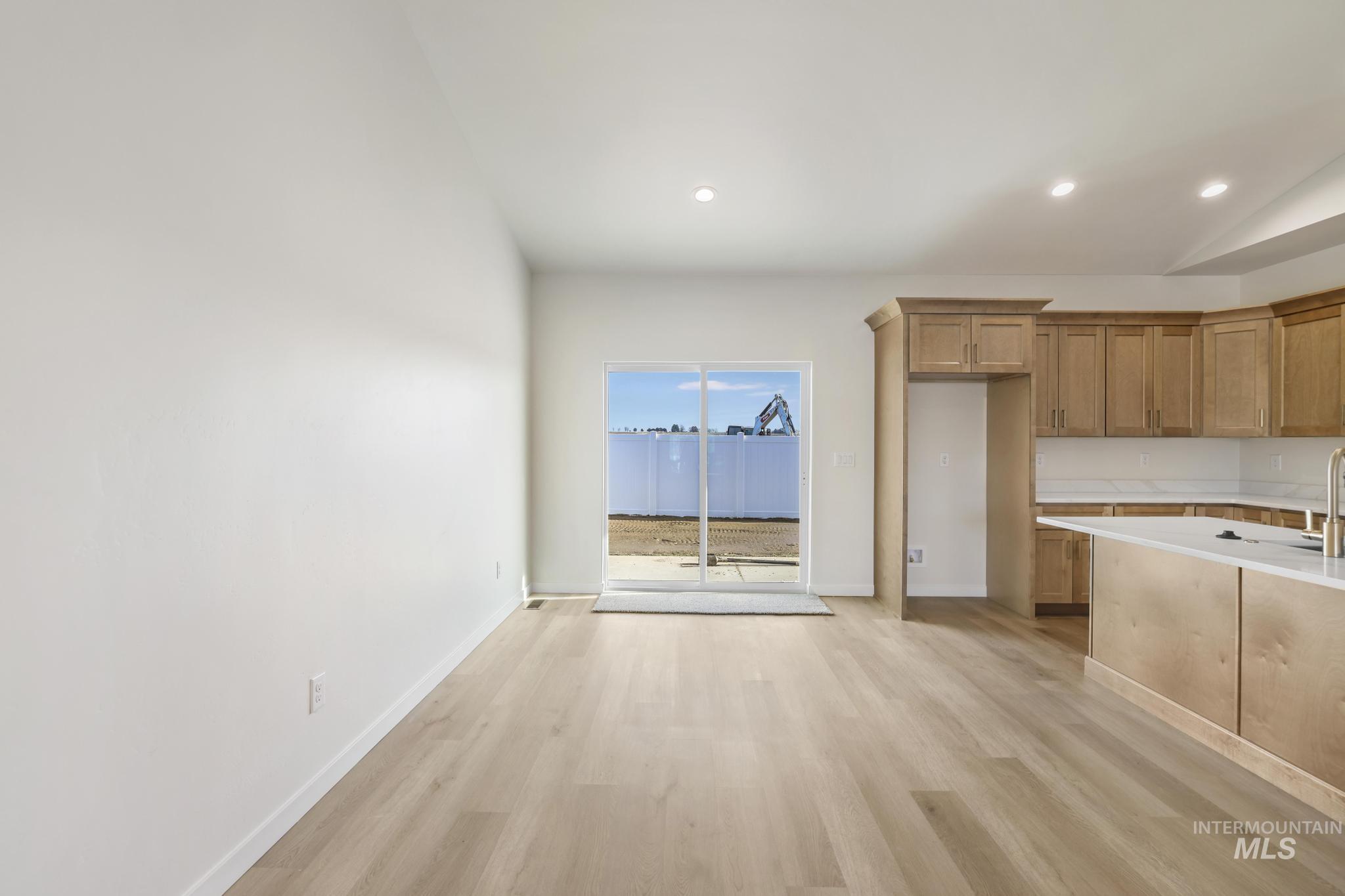 2014 Regan Street Jerome, ID 83338 - Photo 8 of 32 Kitchen with light wood finished floors, brown cabinets, and recessed lighting