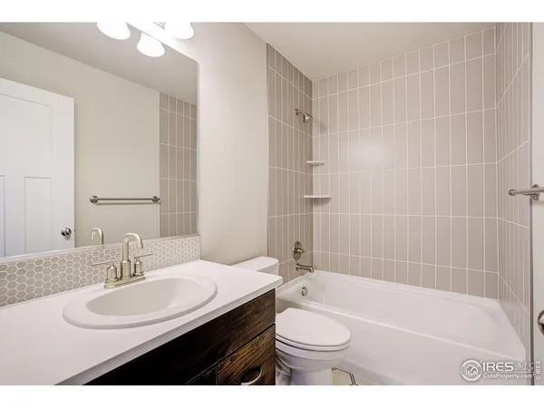 a bathroom with a sink a toilet a shower a mirror and a bathtub