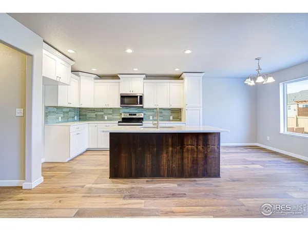 a kitchen with a stove a refrigerator and a sink