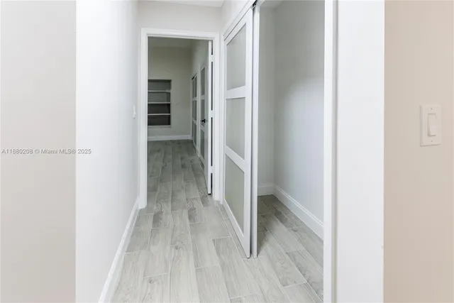 a view of a hallway with wooden floor