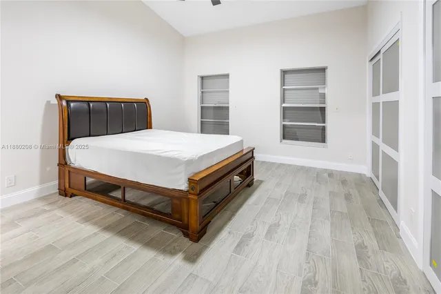 a bed sitting in a bedroom next to a window