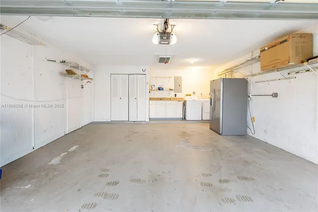a view of a kitchen with a sink and a refrigerator