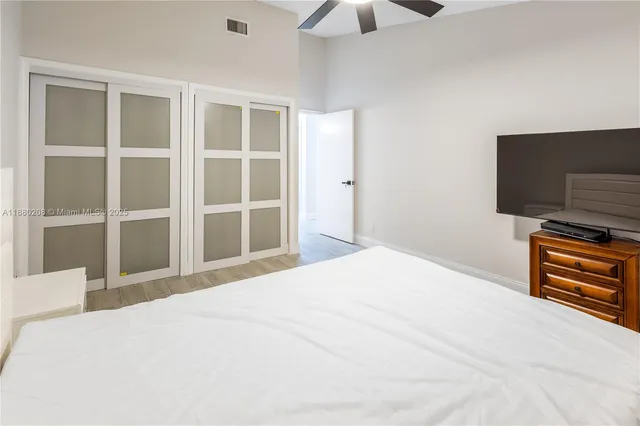 a bedroom with a bed and a flat screen tv