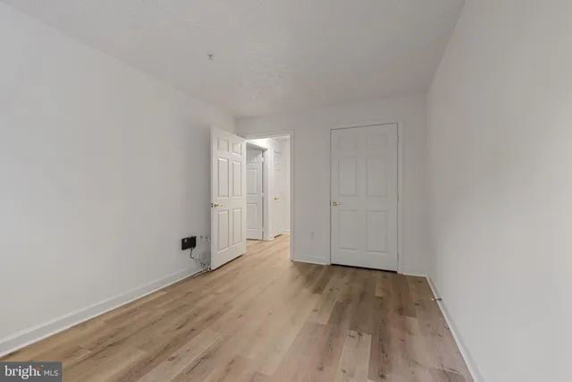 a view of an empty room and wooden floor