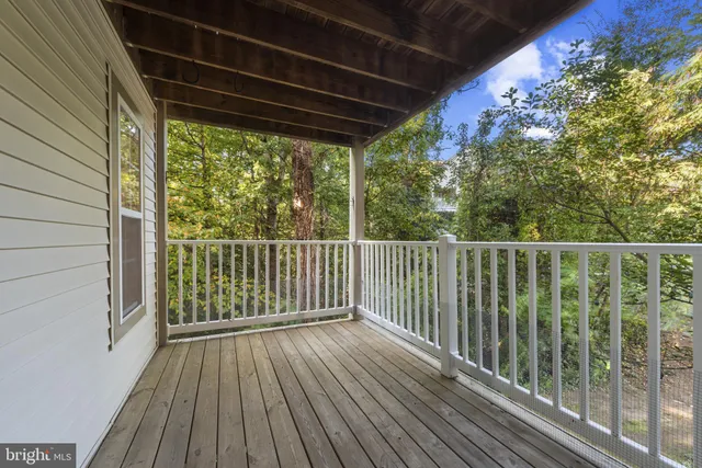 a view of a balcony with wooden floor