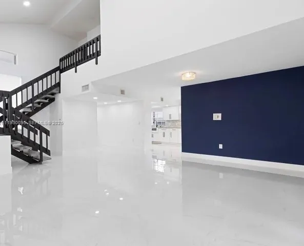 a view of an empty room with stairs