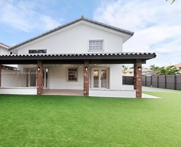 a front view of a house with a garden and yard