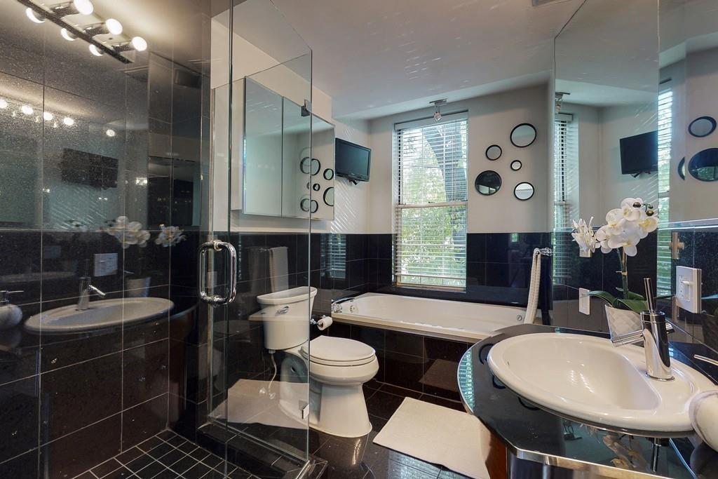 169-171 West 2nd Street Boston, MA 02127 - Photo 11 of 20 a bathroom with a double vanity sink and a mirror