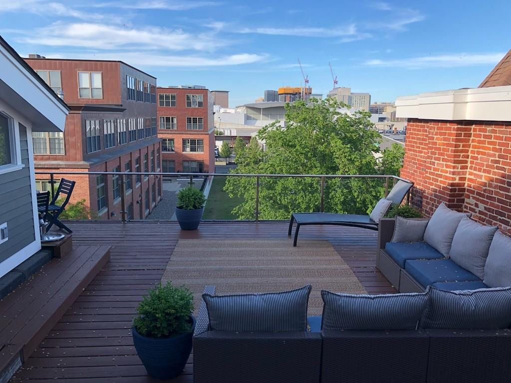 169-171 West 2nd Street Boston, MA 02127 - Photo 18 of 20 a view of a patio with couches chairs potted plants and wooden floor