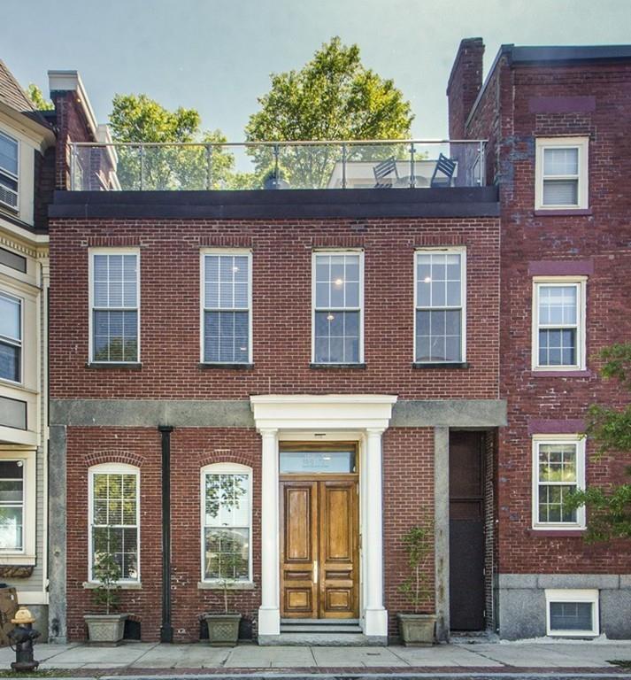 169-171 West 2nd Street Boston, MA 02127 - Photo 19 of 20 a front view of a house with lots of windows and plants