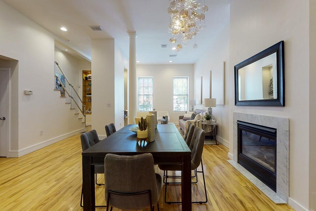 169-171 West 2nd Street Boston, MA 02127 - Photo 2 of 20 a view of a dining room with furniture and wooden floor