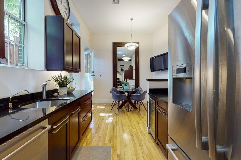 169-171 West 2nd Street Boston, MA 02127 - Photo 4 of 20 a hallway with a large window and stainless steel appliances