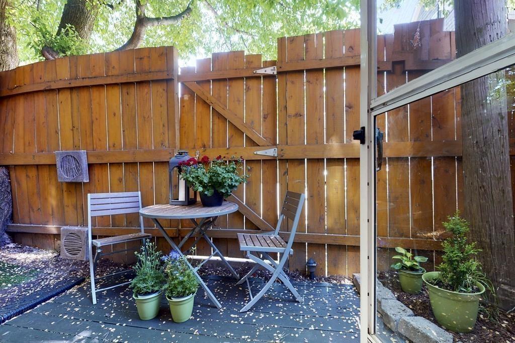 169-171 West 2nd Street Boston, MA 02127 - Photo 5 of 20 a view of balcony with table and chairs potted plants and wooden fence