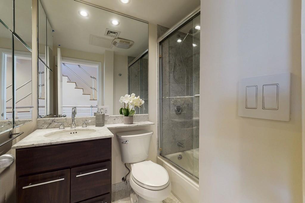 169-171 West 2nd Street Boston, MA 02127 - Photo 8 of 20 a bathroom with a sink a toilet and shower