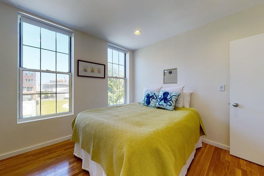 169-171 West 2nd Street Boston, MA 02127 - Photo 9 of 20 a bed sitting in a bedroom next to a window