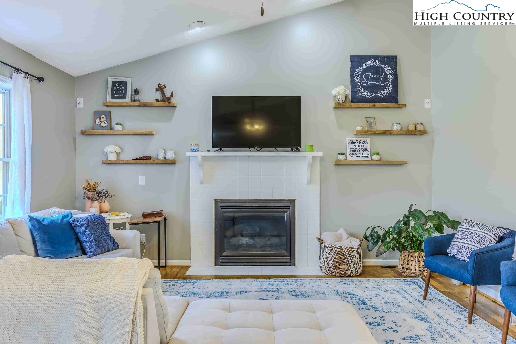 169 Violet Lane Boone, NC 28607 - Photo 11 of 27 a living room with furniture and a flat screen tv