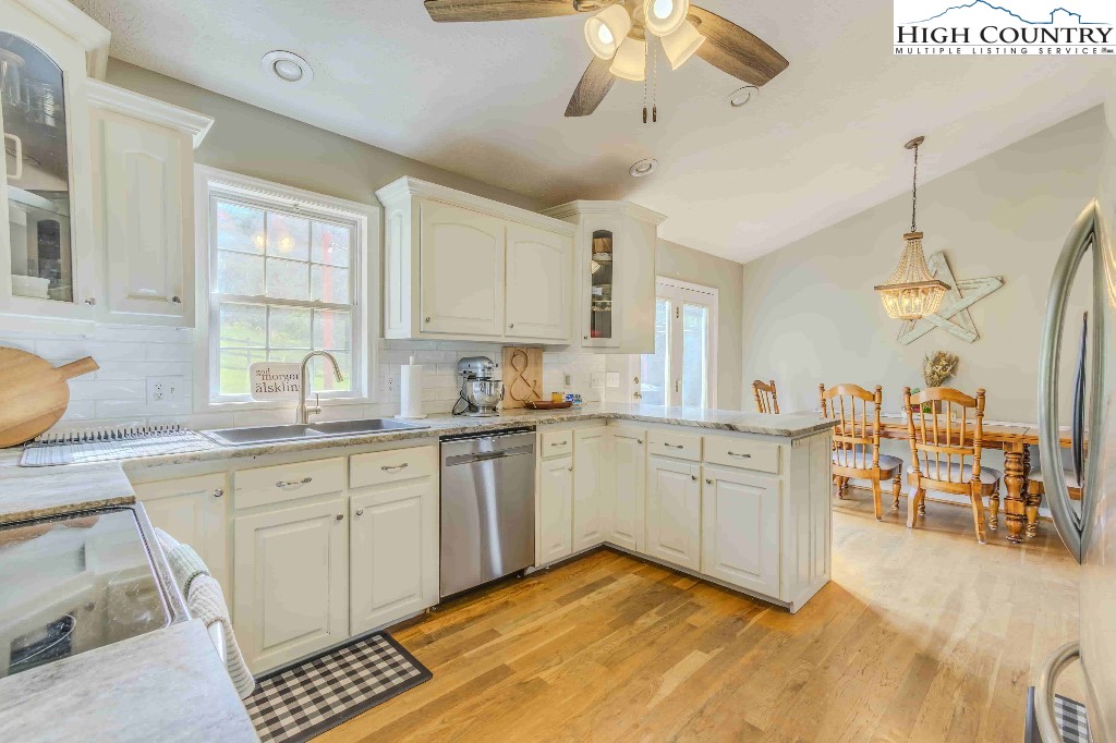 169 Violet Lane Boone, NC 28607 - Photo 14 of 27 a large kitchen with kitchen island a large counter space a sink stainless steel appliances and cabinets