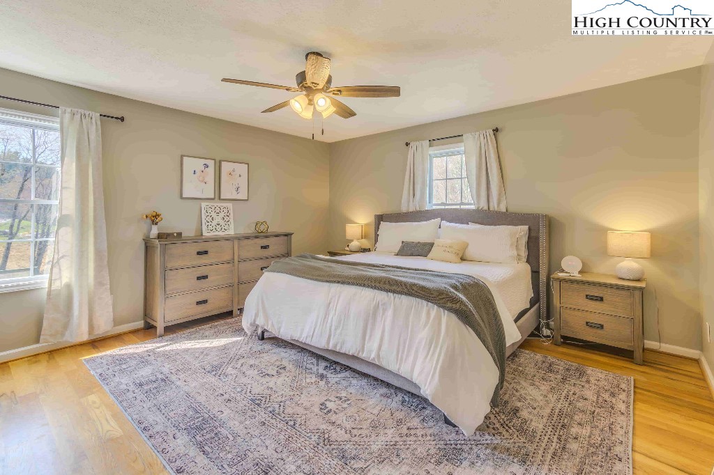 169 Violet Lane Boone, NC 28607 - Photo 3 of 27 a large bedroom with a bed and wooden floor
