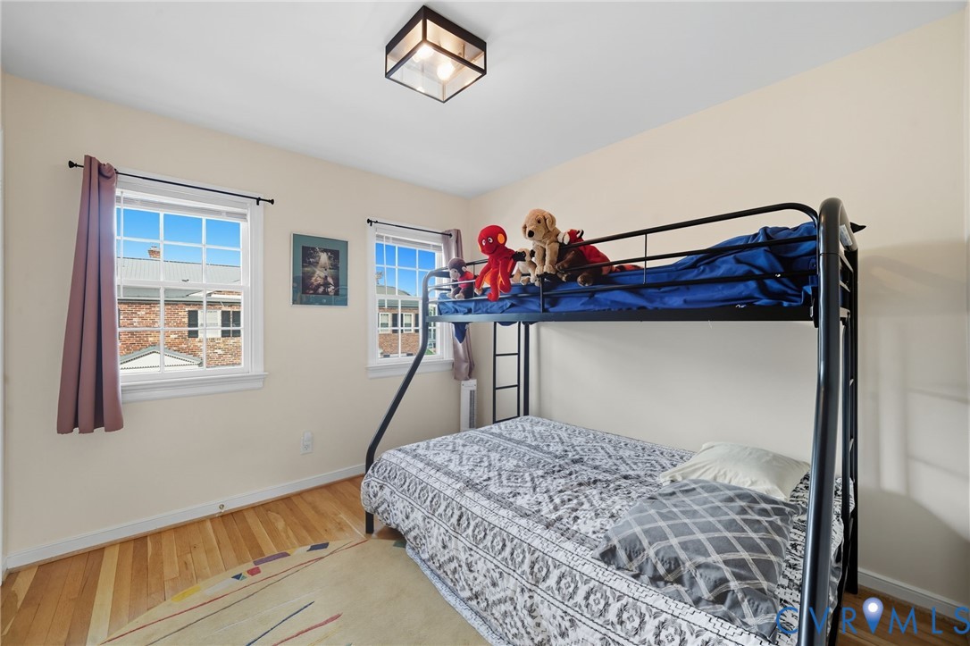 403 North Hamilton Street, Unit J Richmond, VA 23221 - Photo 17 of 27 a bedroom with a bed and a chandelier