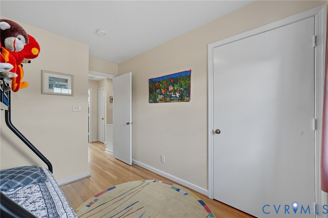 403 North Hamilton Street, Unit J Richmond, VA 23221 - Photo 18 of 27 a view of a hallway with wooden floor and a bookshelf
