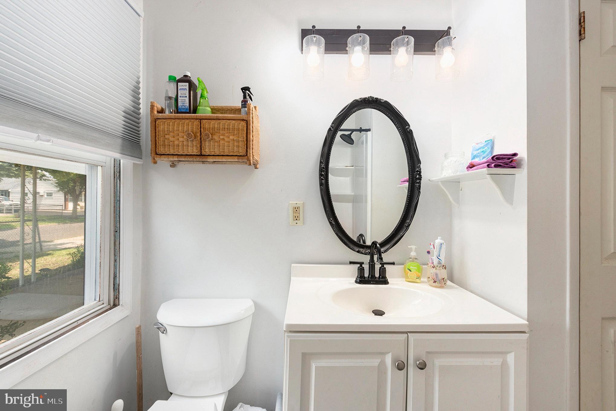 1306 Susan Avenue Croydon, PA 19021 - Photo 20 of 29 a bathroom with a toilet sink and mirror
