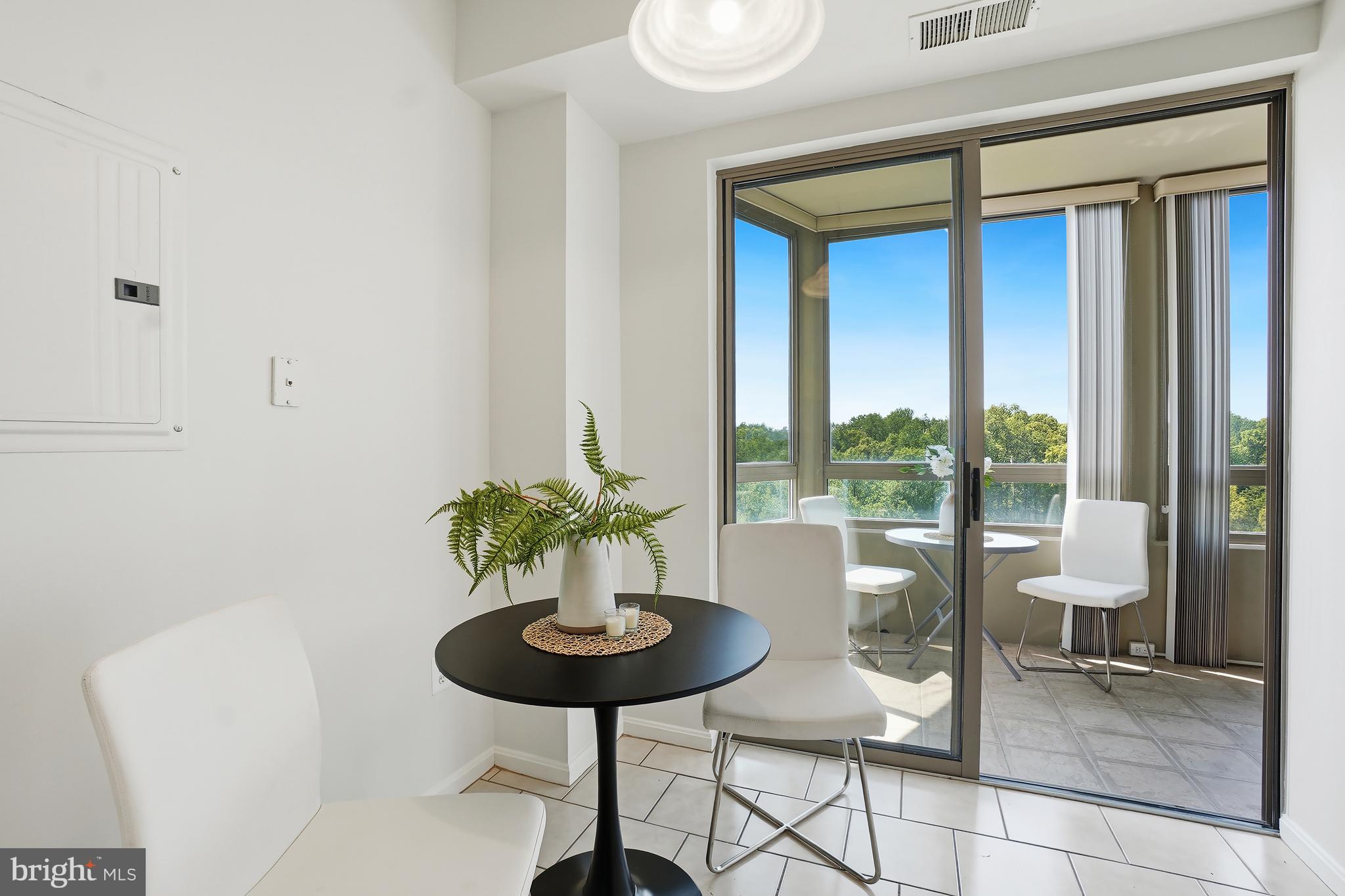 3210 North Leisure World Boulevard, Unit 1001 Silver Spring, MD 20906 - Photo 11 of 58 a view of a dining room with furniture window and outside view