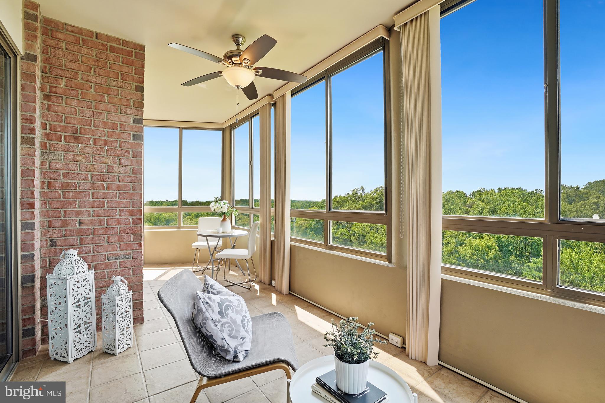 3210 North Leisure World Boulevard, Unit 1001 Silver Spring, MD 20906 - Photo 13 of 58 a living room with furniture and a floor to ceiling window