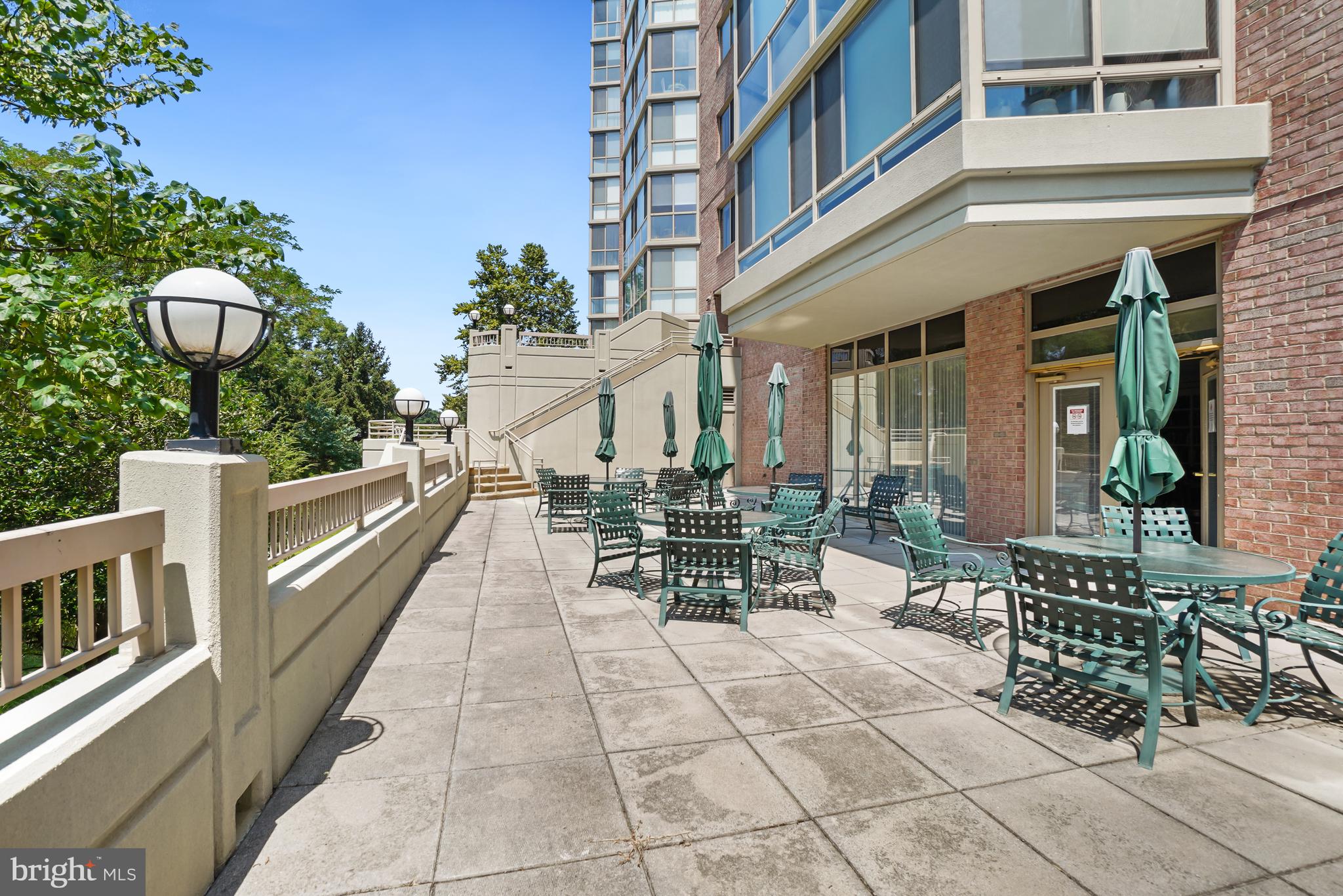 3210 North Leisure World Boulevard, Unit 1001 Silver Spring, MD 20906 - Photo 29 of 58 a view of balcony with chairs and potted plants