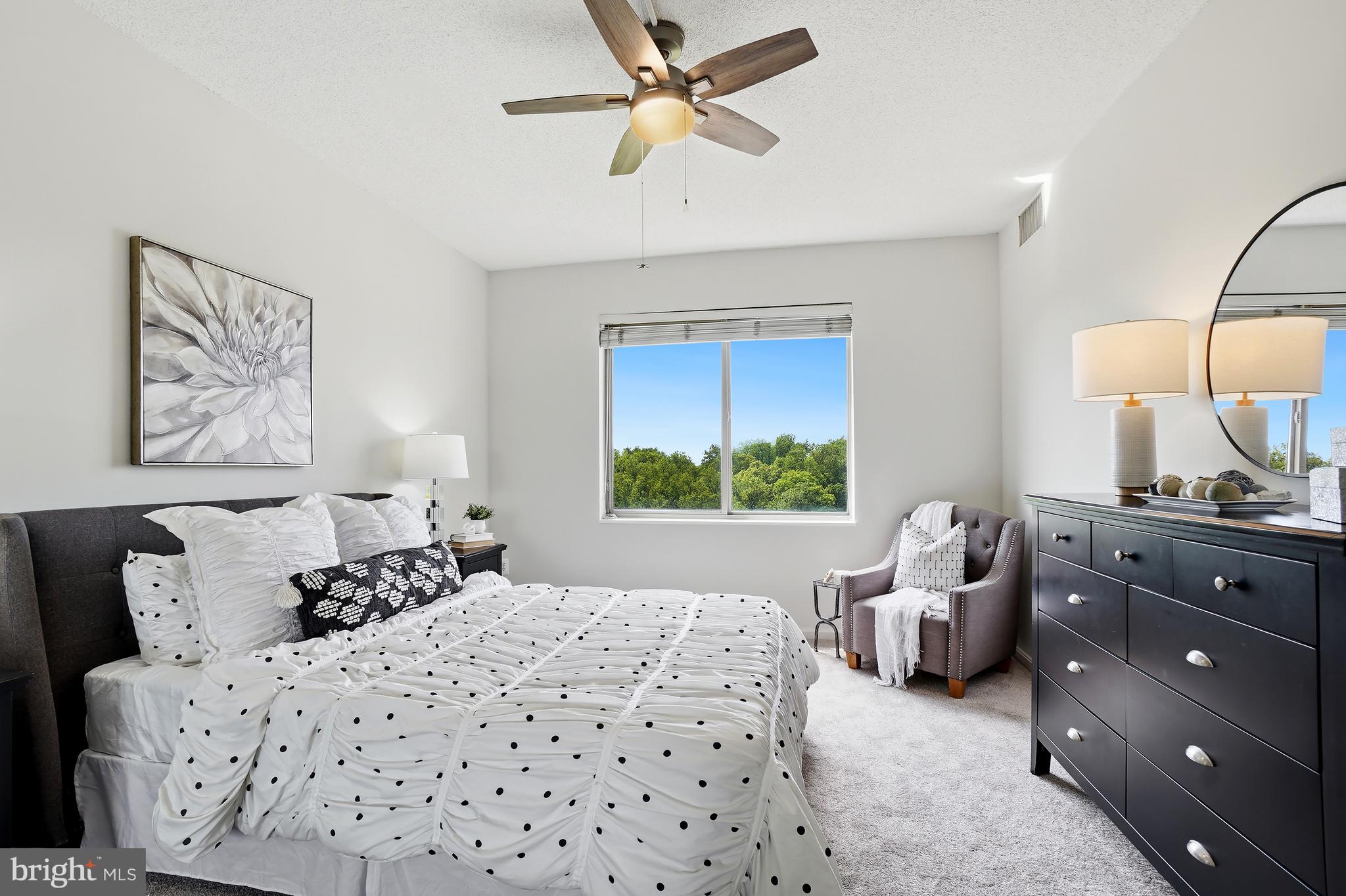 3210 North Leisure World Boulevard, Unit 1001 Silver Spring, MD 20906 - Photo 3 of 58 a bedroom with a bed and a couch